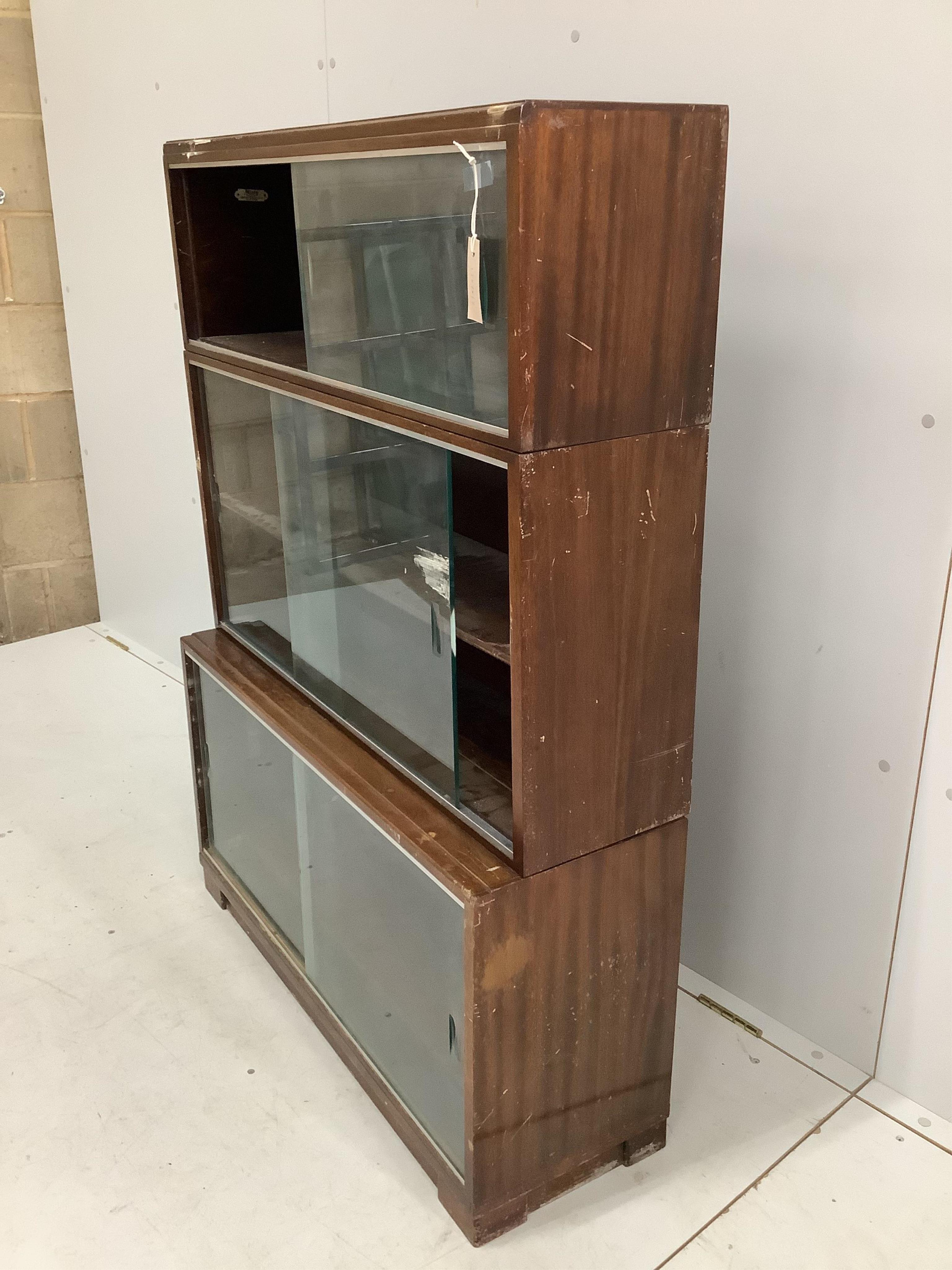 A mid century three section Minty bookcase, width 90cm, height 131cm. Condition - poor